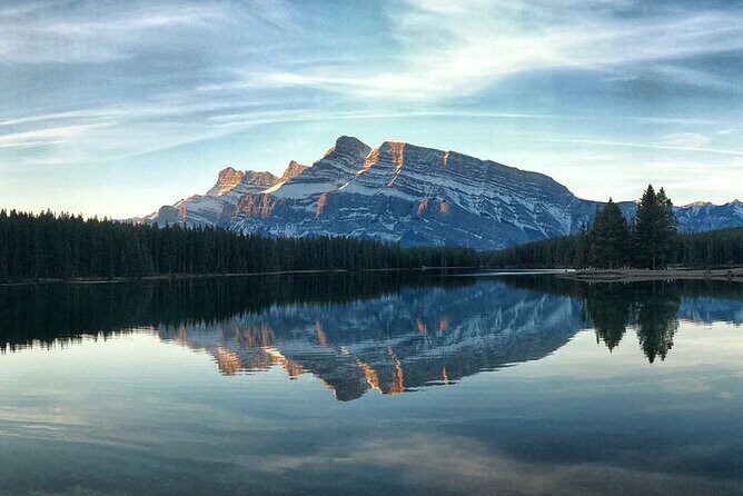 Banff Gondola Hot Springs Bow Falls and Three Lakes tour - Lake Minnewanka: boats allowed, and history under the water