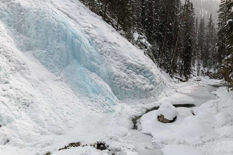 From Banff: Johnston Canyon Guided Icewalk - Lower Falls with the tunnel: the close-up that changes everything