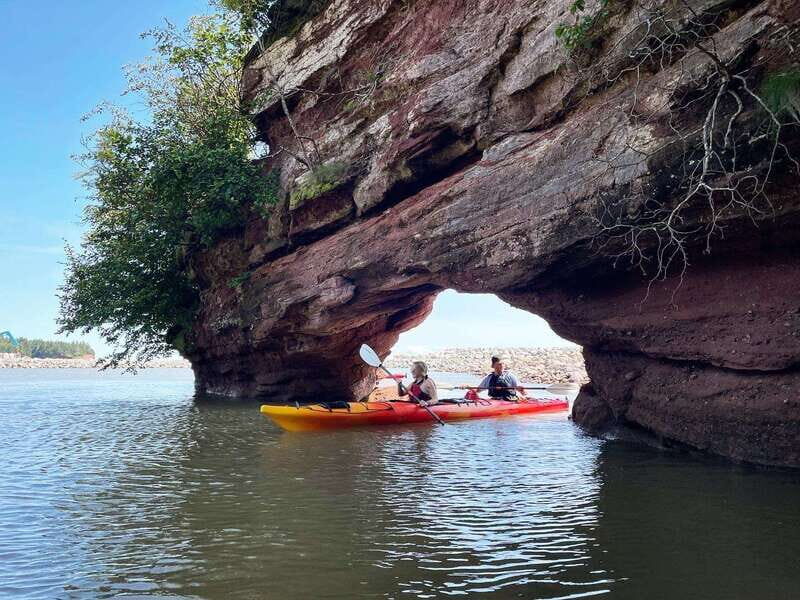 Saint John: Guided Kayaking Tour of St. Martins Sea Caves - The Launch Scene: Covered Bridges, Fishing Boats, and Bay of Fundy Light